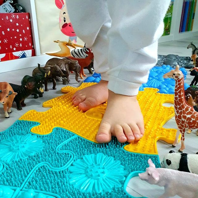 boy walking barefoot on a non-toxic toys from tinnitots australia