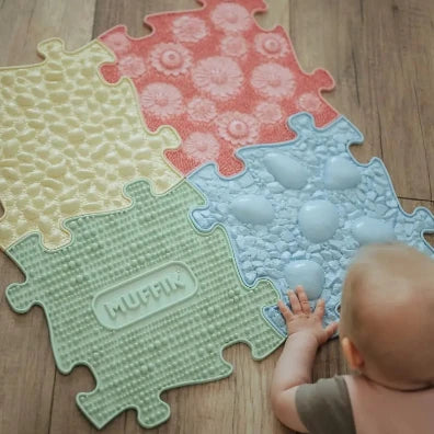 CHILD PLAYING WITH SENSORY MATS
