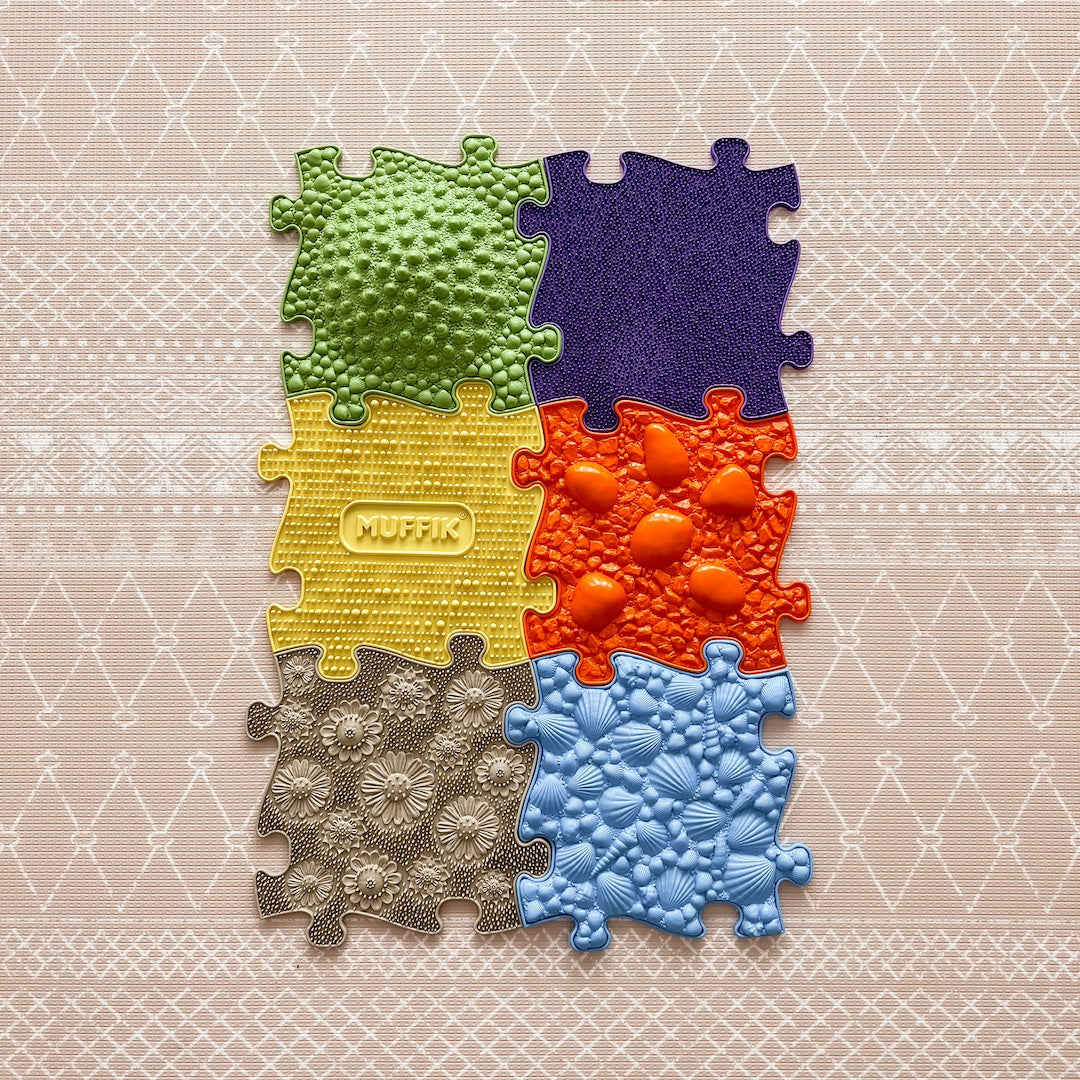 Colorful puzzle piece for babies and toddlers, perfect for tactile play on waterproof mats by Muffik and Tinnitots