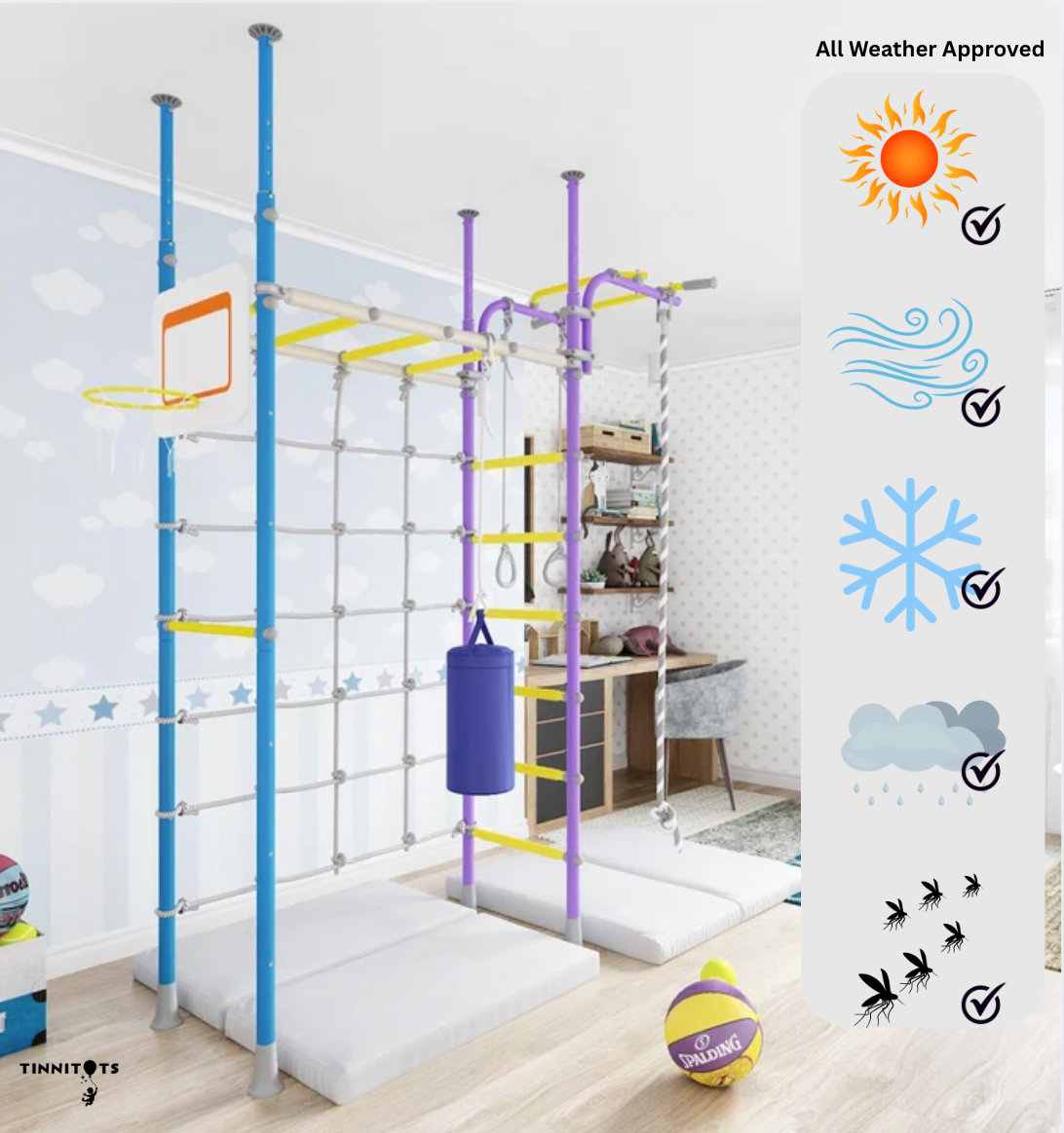 A bright and cheerful children's indoor playroom featuring a colourful monkey bar set with blue, purple, and yellow elements, including a rope, ladder, and punching bag