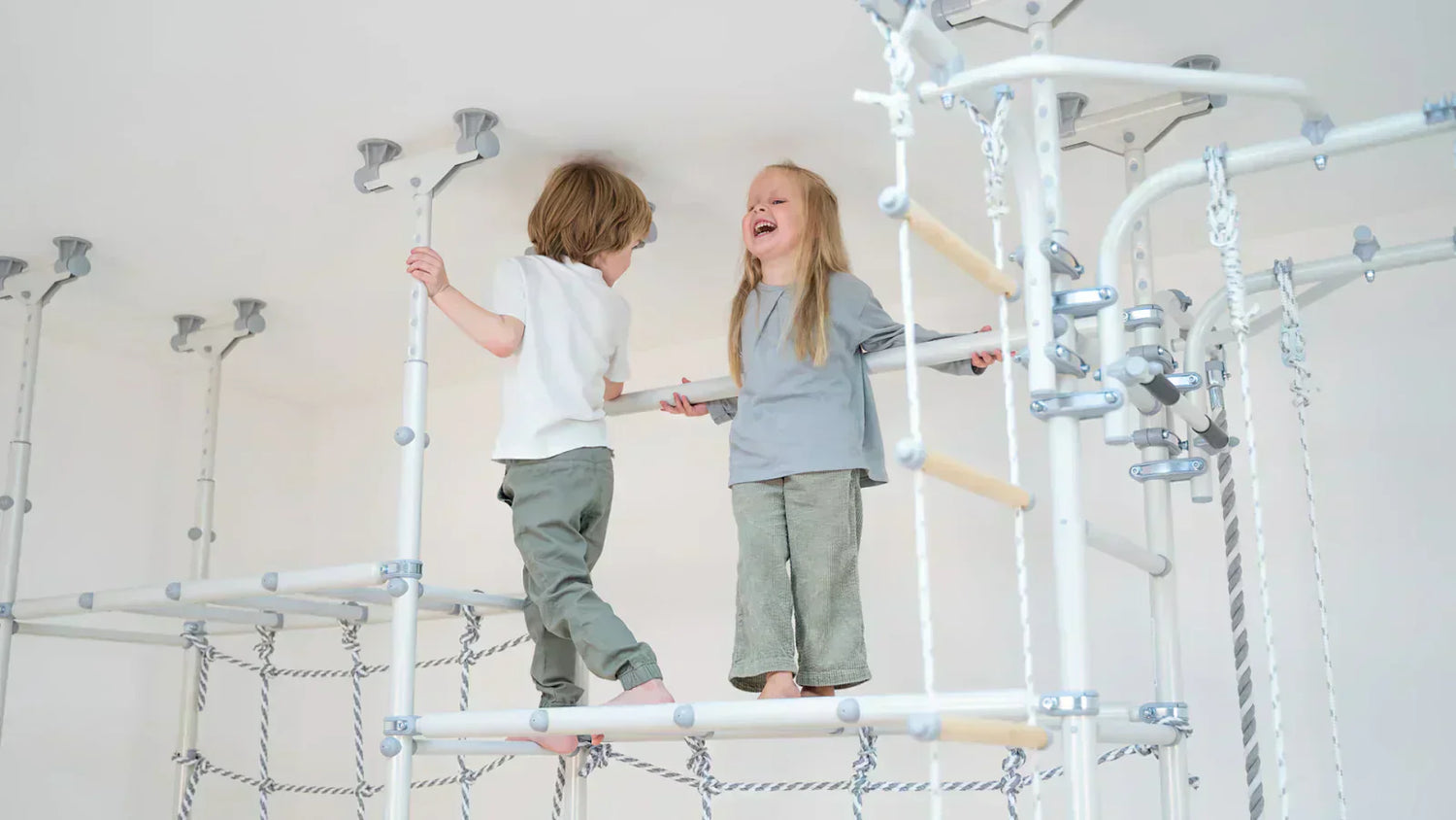 two children standing on top of No-Drill Indoor Monkey Bars for Renters & Apartments 