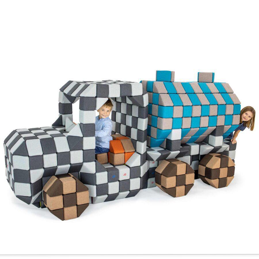 Soft Toys from Tinnitots where a girl and a boy is riding on a colourful tractor which is made of soft magnetic blocks