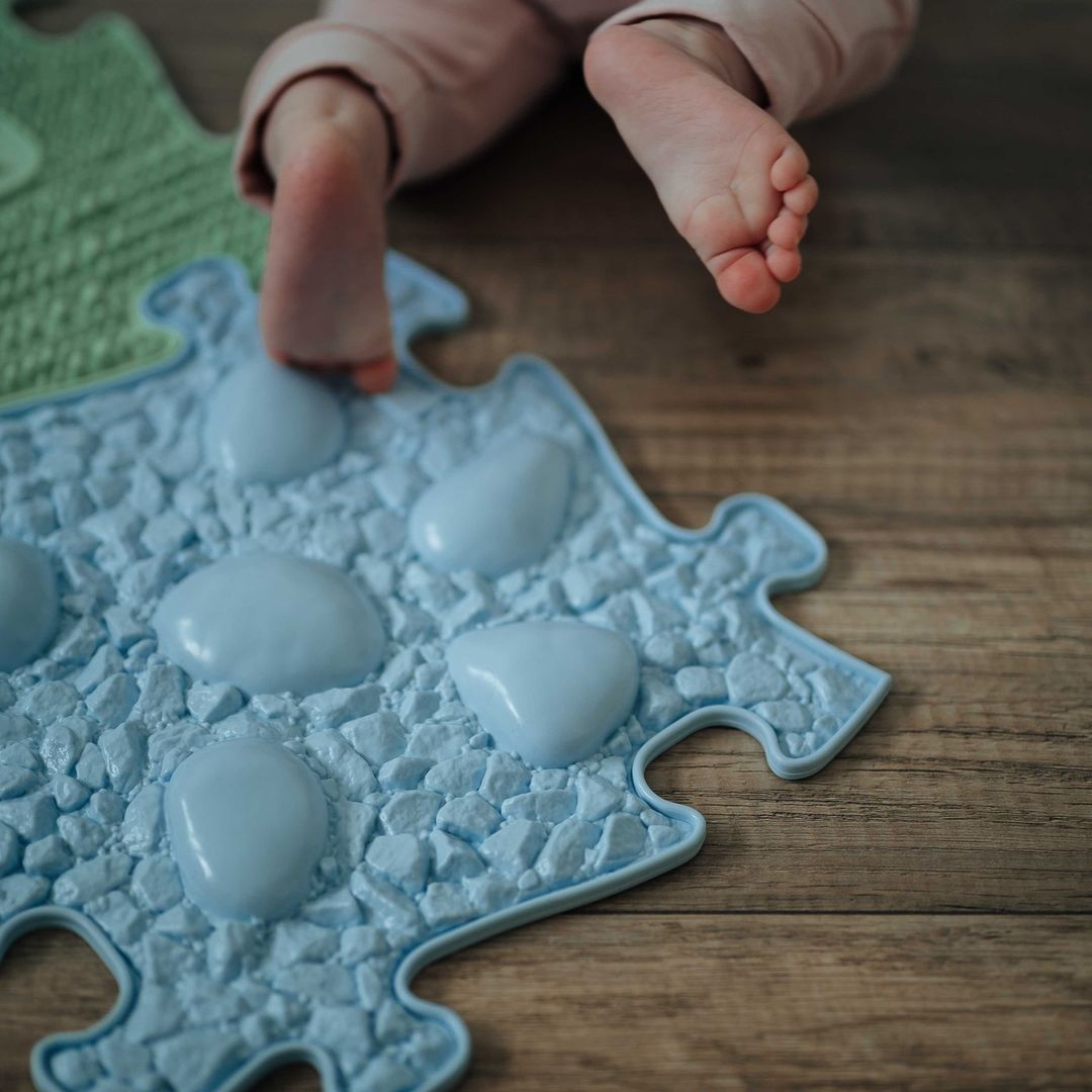 babies toes touching the sensory mat for sensory skills. shop at Tinnitots