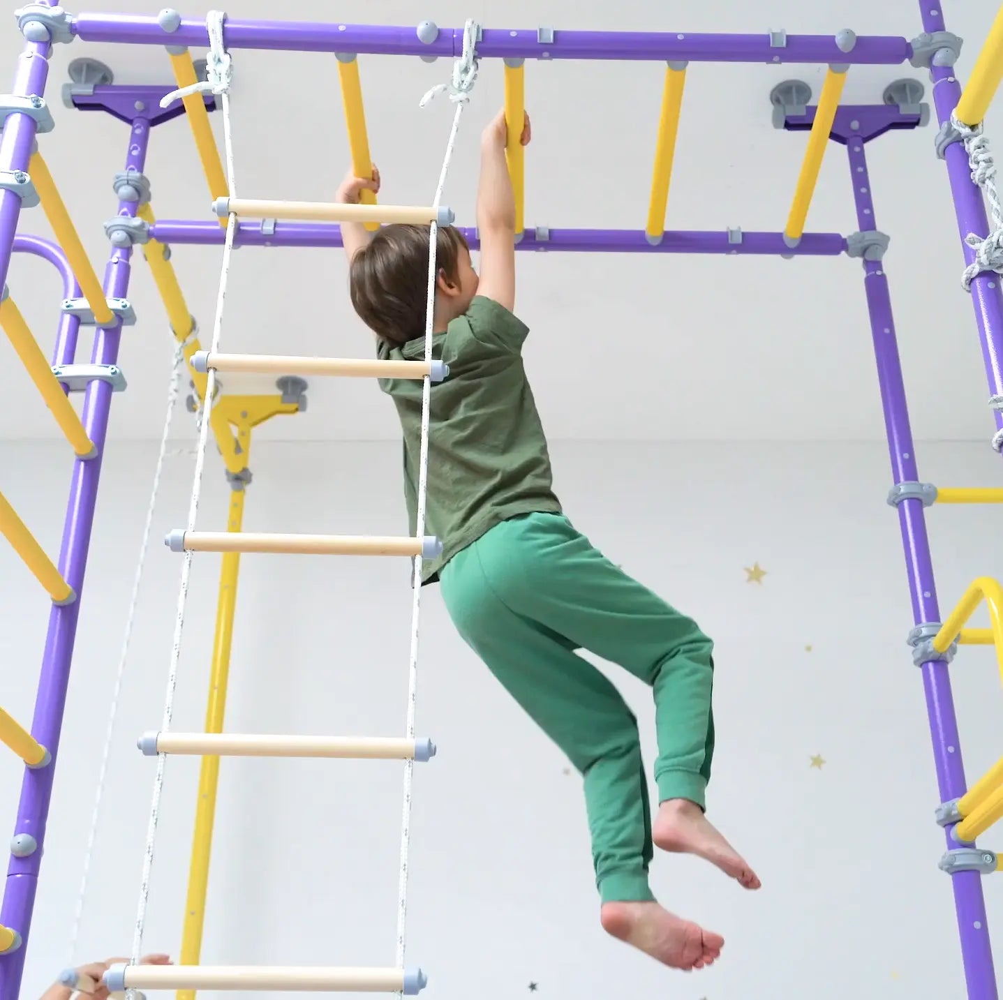 Child playing on Ninja Home Play Set no-drill indoor monkey bars – Tinnitots Australia