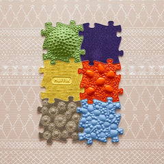 Colorful puzzle piece for babies and toddlers, perfect for tactile play on waterproof mats by Muffik and Tinnitots